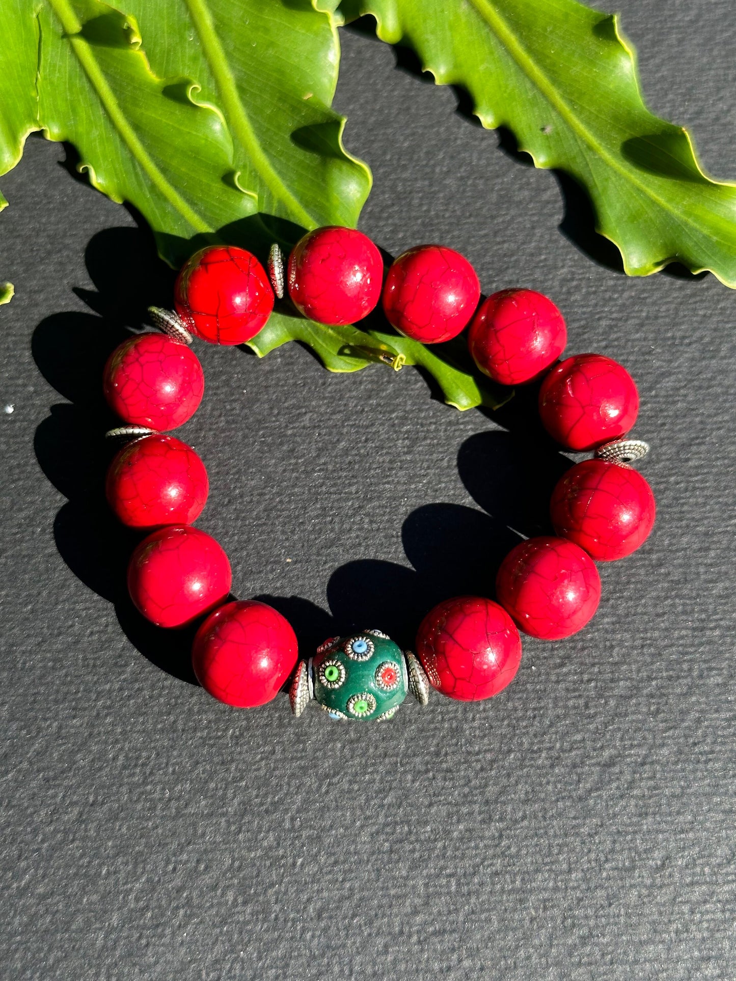 Red Beaded Bracelet with Green Focal Bead